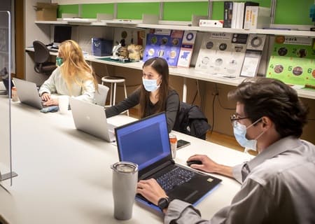 Students participate in class with masks.